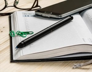 day planner book with pen and phone on table